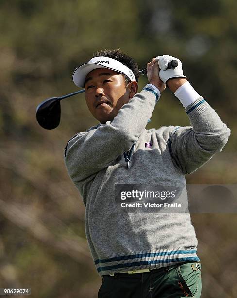 Tetsuji Hiratsuka of Japan tees off on the 9th hole during the fog-delayed Round One of the Ballantine's Championship at Pinx Golf Club on April 23,...