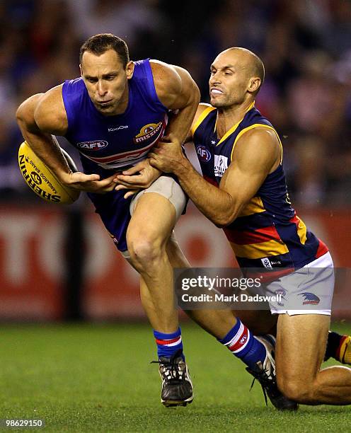 Mitch Hahn of the Bulldogs is tackled by Tyson Edwards of the Crows during the round five AFL match between the Western Bulldogs and the Adelaide...