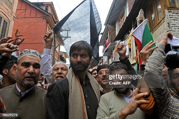 Chairman of Jammu and Kashmir Liberation Front Yasin Malik walks with activists during a protest in Srinagar on April 23, 2010. Police detained...