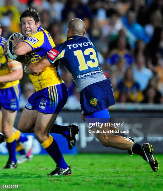 Nathan Cayliss of the Eels is tackled by Steve Rapira of the Cowboys during the round seven NRL match between the North Queensland Cowboys and the...