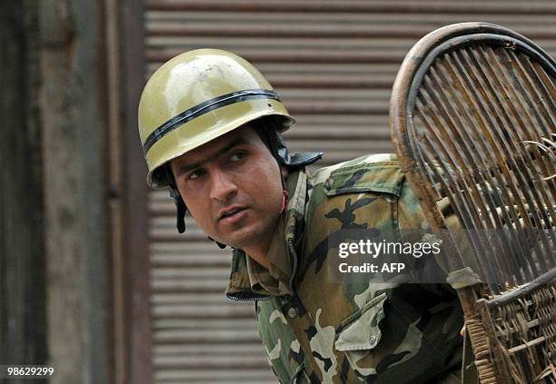 An Indian policeman looks on during a clash with Kashmiri protestors in Srinagar on April 23, 2010. Police detained activists including the chairman...