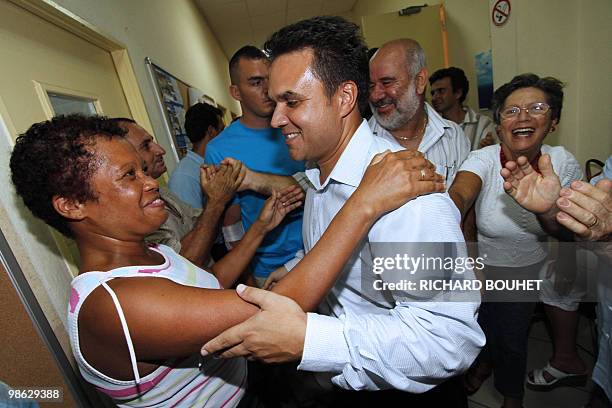French MP Didier Robert, the candidate of right-wing UMP ruling party in the French Indian island of La Reunion, is congratulated after he announced...