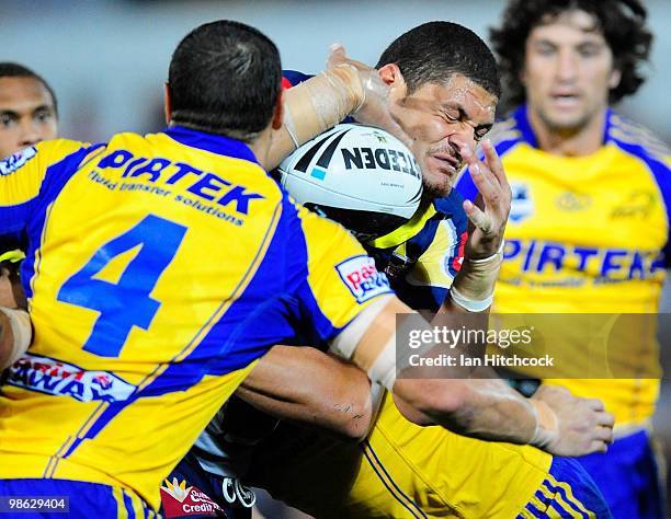 Willie Mason of the Cowboys is wrapped up by the Eels defence during the round seven NRL match between the North Queensland Cowboys and the...