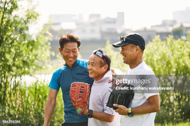 three senior men before or after playing baseball in a park - 運動　日本人 ストックフォトと画像