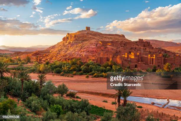 sunset over ait benhaddou - ancient city in morocco north africa - desert oasis stock pictures, royalty-free photos & images