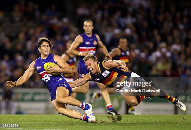 Nathan van Berlo of the Crows tackles Ryan Griffin of the Bulldogs during the round five AFL match between the Western Bulldogs and the Adelaide...