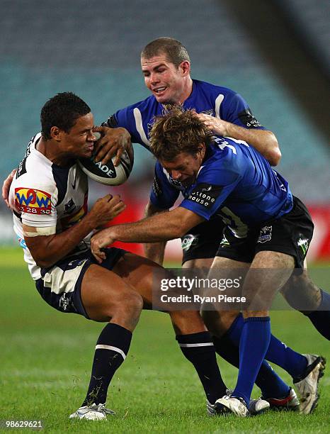 Josh Hoffman of the Broncos is tackled by Brett Kimmorley and Andrew Ryan of the Bulldogs during the round seven NRL match between the Canterbury...