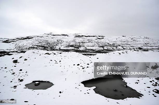 Glacial water accumultes in small pools at the base of the Myrdalsjokull glacier, which is part of the ice cap sealing the Katla volcano, near the...