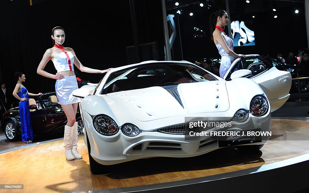 Models poses beside a Japanese Mitsuoka