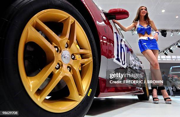 Model poses beside a Hyundai Elantra during a media preview at the Beiijng Auto Show on April 23, 2010. Auto sales in booming China hit 13.64 million...