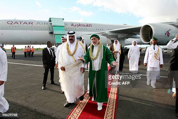Quatar's Sheikh Hamad bin Khalifa al-Thani is welcomed by Comoros's current President Ahmed Abdalah Sambi upon arrival at Anjouan's airport, on the...