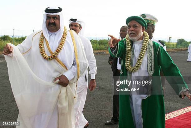 Quatar's Sheikh Hamad bin Khalifa al-Thani and Comoros's current President Ahmed Abdalah Sambi walk on the tarmac of the Anjouan airport, the Comoran...