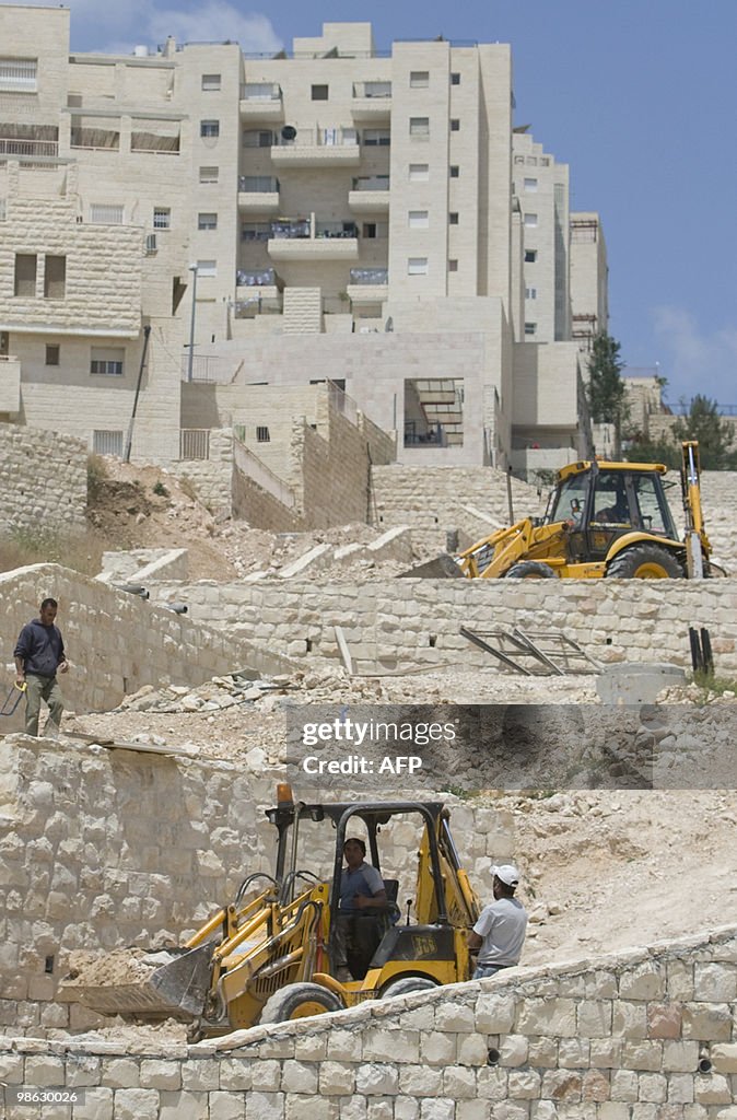 Palestinian labourers work on a new hous