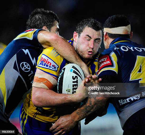 Ben Smith of the Eels is tackled by Willie Tonga and John Williams of the Cowboys during the round seven NRL match between the North Queensland...