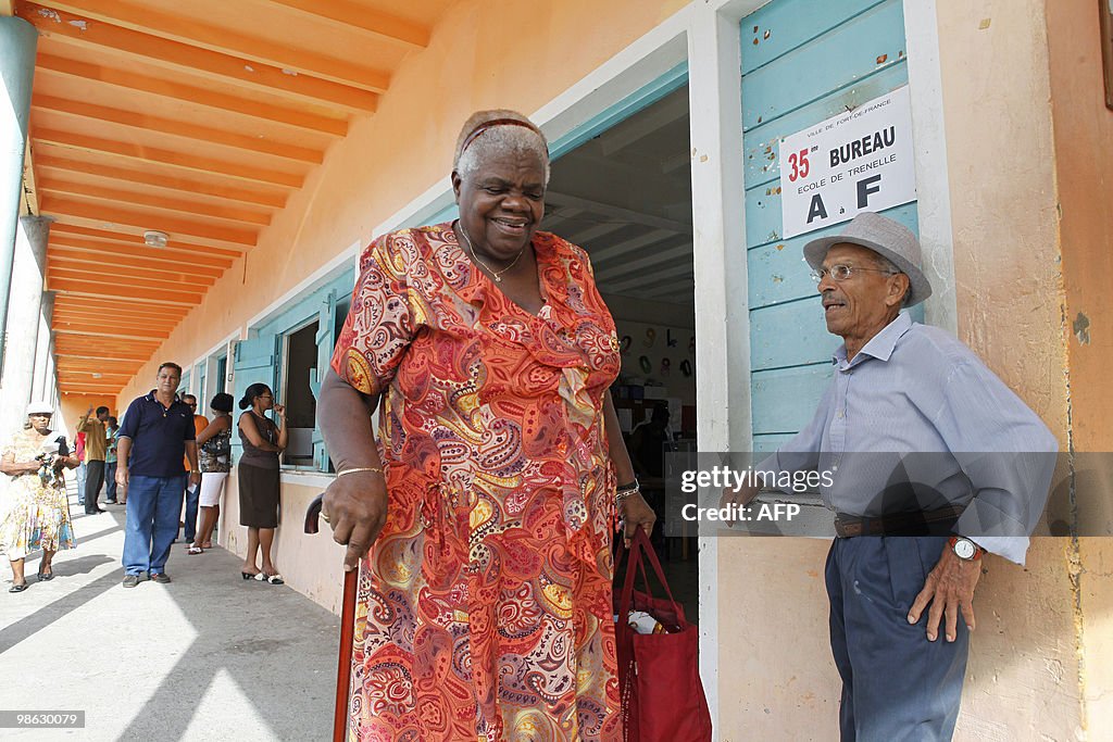 A woman leaves a polling station after v