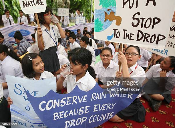 School children hold placards at a World Earth Day rally organised by UNESCO and WWF in New Delhi on April 22, 2010.