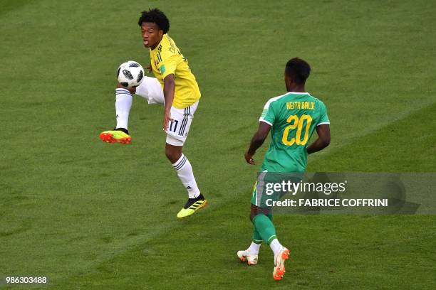 Colombia's forward Juan Cuadrado controls the ball next to Senegal's forward Keita Balde during the Russia 2018 World Cup Group H football match...