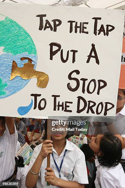 School children hold Save Water placards at a World Earth Day rally organised by UNESCO and WWF in New Delhi on April 22, 2010.