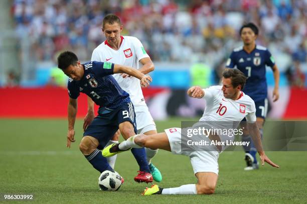 Grzegorz Krychowiak of Poland tackles Shinji Okazaki of Japan during the 2018 FIFA World Cup Russia group H match between Japan and Poland at...