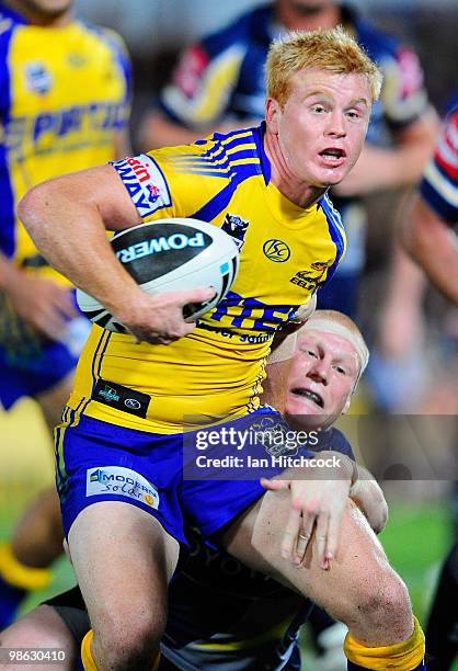 Kris Keating of the Eels is tackled by Anthony Watts of the Cowboys during the round seven NRL match between the North Queensland Cowboys and the...