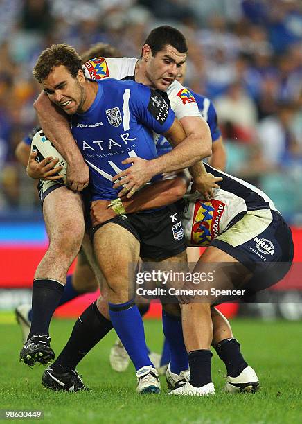 Gary Warburton of the Bulldogs is tackled during the round seven NRL match between the Canterbury Bulldogs and the Brisbane Broncos at ANZ Stadium on...