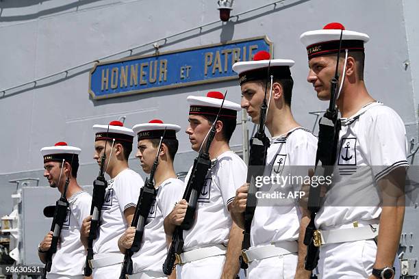 French marine honor guards stand on March 22 on the deck of French helicopter-carrier Jeanne d'Arc, as it leaves Fort-de-France on the French island...