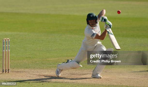 Ben Cox of Worcestershire hits out watched by Riki Wessels of Nottinghamshire during the Specsavers County Championship Division One match between...