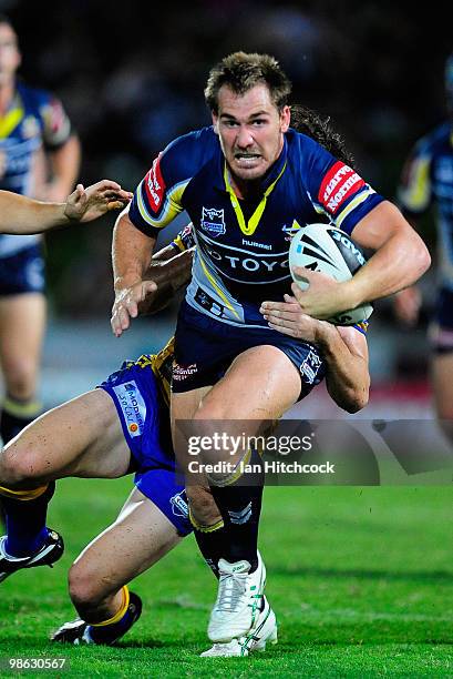 Scott Bolton of the Cowboys looks to get past the tackle of Joel Reddy of the Eels during the round seven NRL match between the North Queensland...