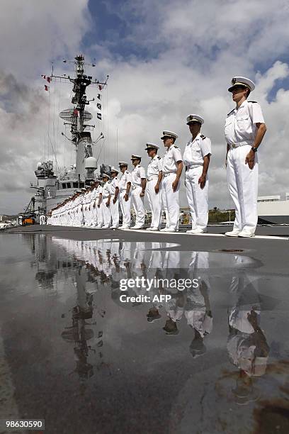 French crew members stand on March 22 on the deck of French helicopter-carrier Jeanne d'Arc, as it leaves Fort-de-France on the French island of La...