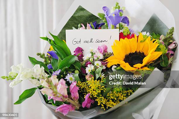bunch of flowers with "get well soon" message. - get well soon stock-fotos und bilder