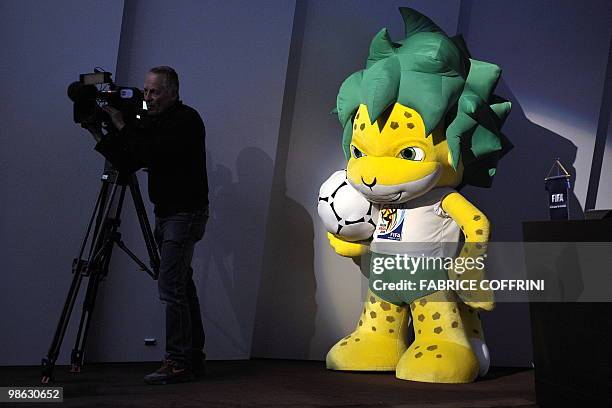 Zakumi, the FIFA 2010 World Cup mascot stands behind a TV operator during a press conference on April 23, 2010 at the football's governing body...