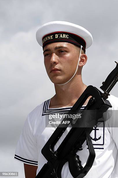 French marine honor guard stands on March 22 on the deck of French helicopter-carrier Jeanne d'Arc, as it leaves Fort-de-France on the French island...