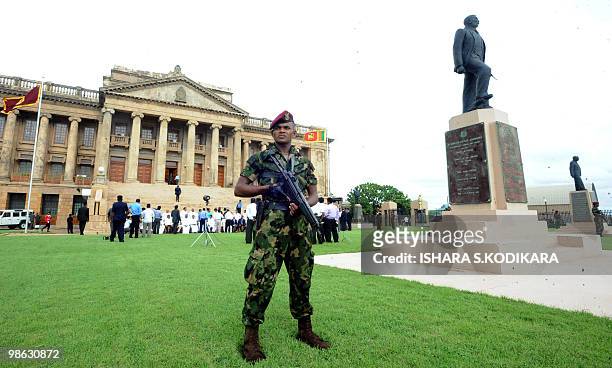 Sri Lankan special forces commando stands guard outside the parliament in Colombo on April 23, 2010. Sri Lanka's new Cabinet was sworn in by Sri...