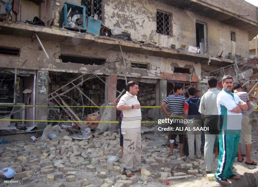 Iraqis gather at the scene of a car bomb