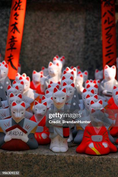 long lines of foxes - inari shrine stock pictures, royalty-free photos & images