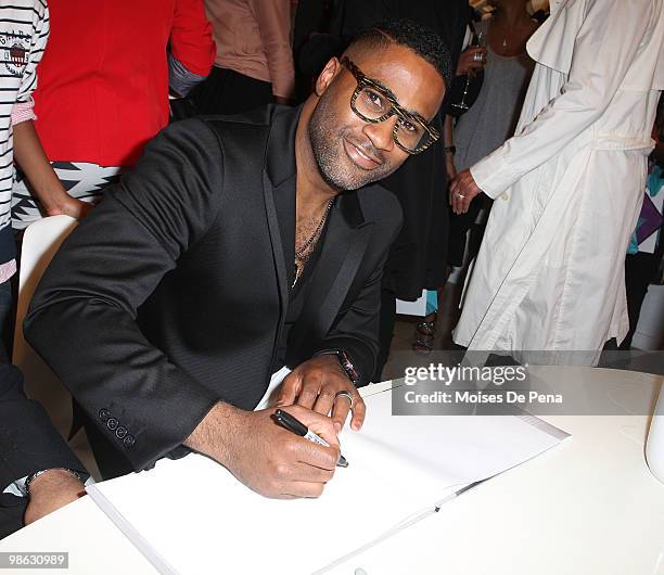 Kieth Cambell signs a book during the "Cuts Of Our Infirmities" book launch party at the Tracy Reese Boutique on April 22, 2010 in New York City.