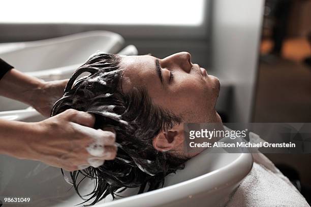 man getting hair washed in sink at salon - tvätta håret bildbanksfoton och bilder