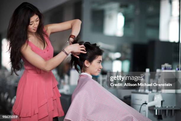 teenage girl getting hair done in salon - girl hair cut stock pictures, royalty-free photos & images