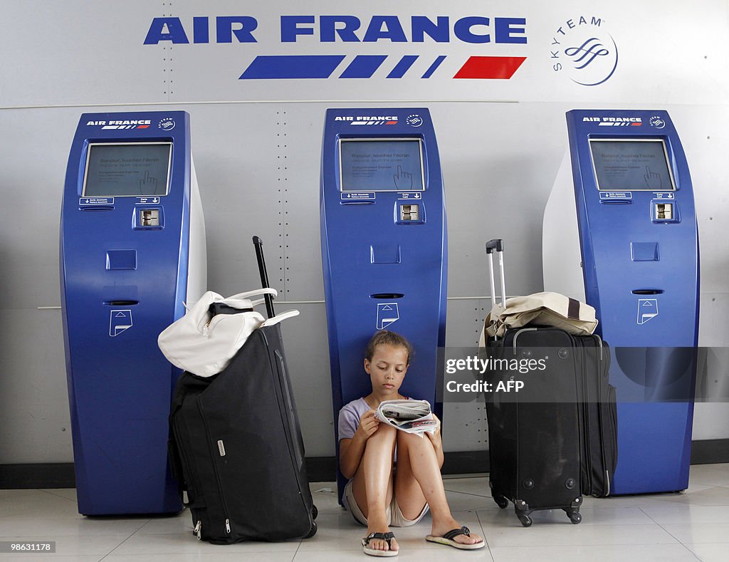 A girl reads as she waits for a flight w