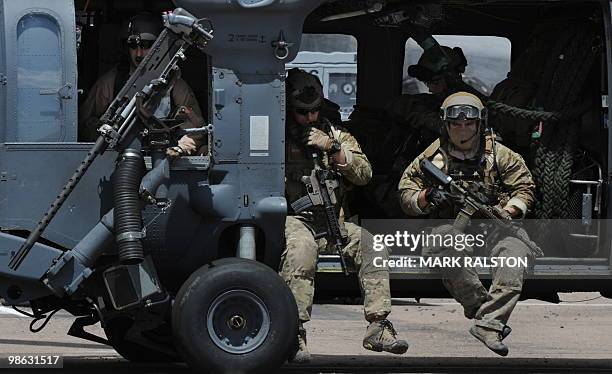 Troops onboard Air Force HH-60 Pave Hawk helicopters leave to conduct a rescue operation during Exercise Angel Thunder, near the town of Bisbee in...