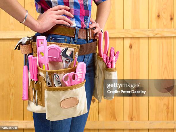 builder with pink tools in belt - pink belt stock pictures, royalty-free photos & images