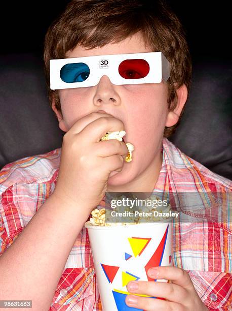 overweight boy in cinema - kinosaal stock-fotos und bilder