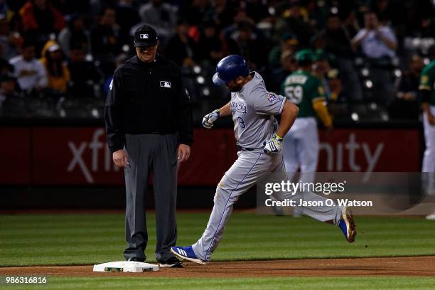 Mike Moustakas of the Kansas City Royals rounds the bases after hitting a home run against the Oakland Athletics during the eighth inning at the...