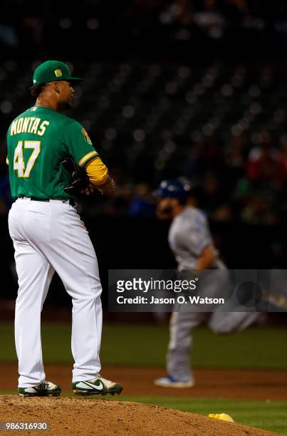 Mike Moustakas of the Kansas City Royals rounds the bases after hitting a home run off of Frankie Montas of the Oakland Athletics during the eighth...
