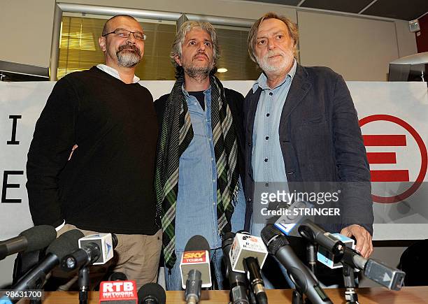 Italian aid workers Marco Garatti and Matteo Dell'Aira from the aid agency "Emergency" pose with the founder of Italian medical organization...