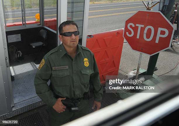 Border Patrol officer inspects vehicles at a checkpoint near the Mexican border at the town of Tombstone, Arizona on April 21, 2010. Two Republican...