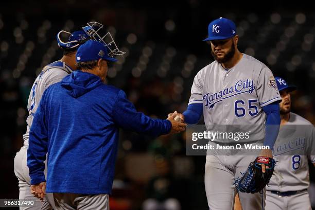 Jakob Junis of the Kansas City Royals is relieved by manager Ned Yost during the sixth inning against the Oakland Athletics at the Oakland Coliseum...