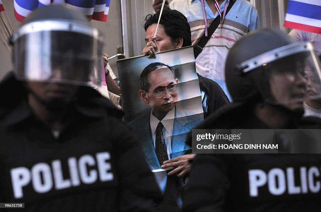 A Thai pro-government protester holds a