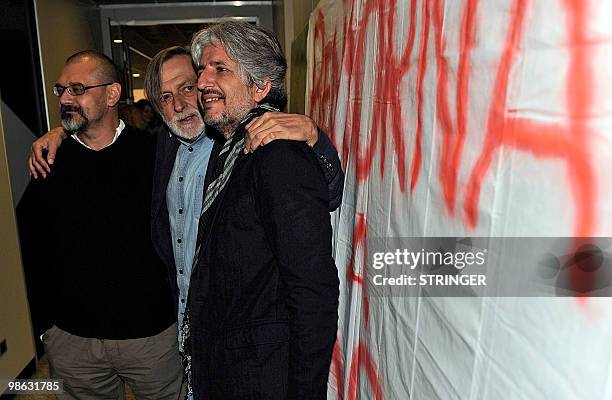 Italian aid workers Marco Garatti and Matteo Dell'Aira from the aid agency "Emergency" pose with the founder of Italian medical organization...