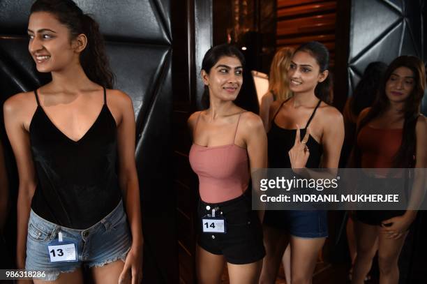 Models interact while waiting for the Lakmé Fashion Week Winter/Festive 2018 edition model auditions in Mumbai on June 28, 2018. - Lakmé Fashion...